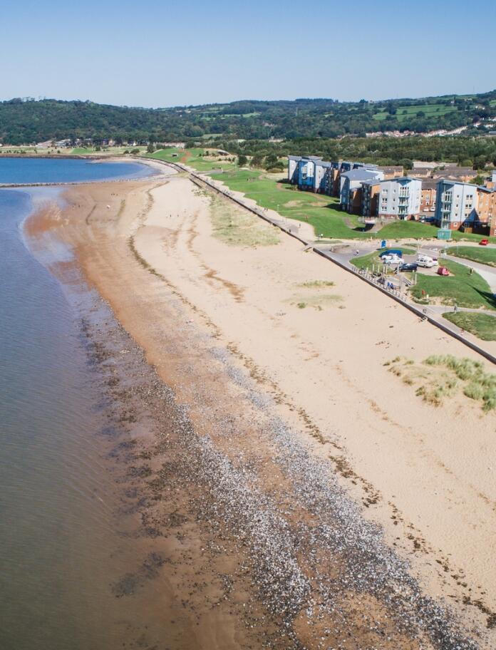 Aerial view of a sandy beach-fronted town.