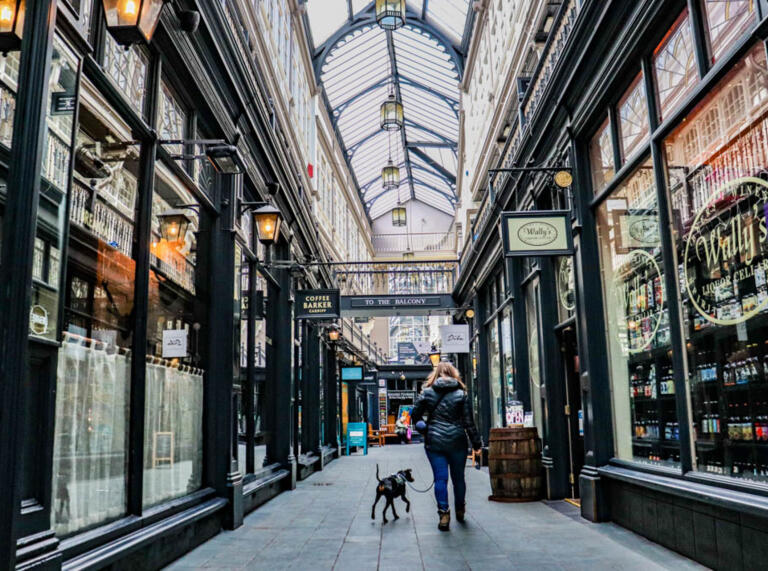 Lottie and her dog Arty walking through an arcade