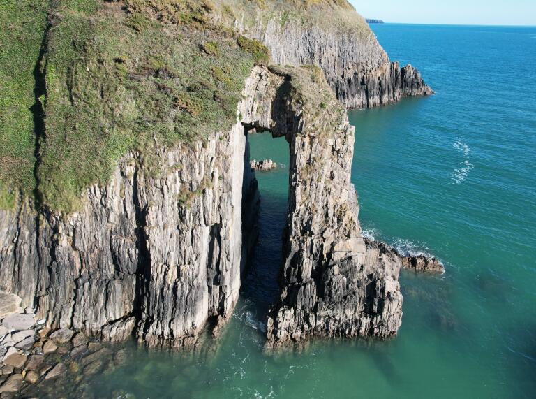 A cliff with a door-shaped hole in the rock.