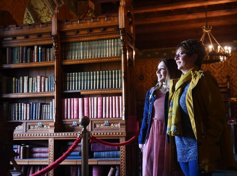 two woman in castle library.