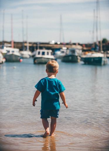 A small boy paddling in the sea at Saundersfoot.