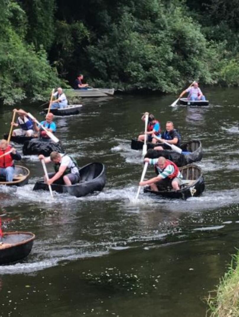 A group of people racing in coracles in West Wales.