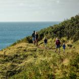 Family walking on coastal path at Aberdaron.