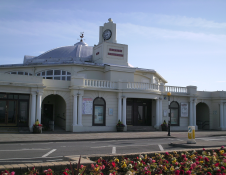 exterior of white building with flowers in foreground