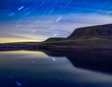 star trails over lake.