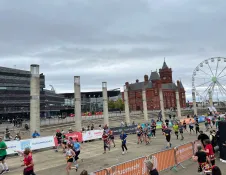 half marathon runners with spectators watching.