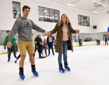 Two people skating across the ice.
