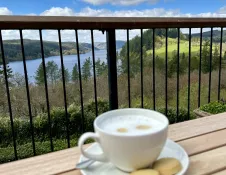 Coffee mug with the backdrop of mountains and blue sky