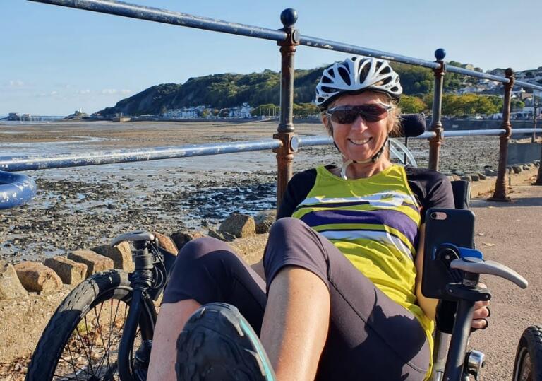 Woman on a recumbent trike on a seafront 