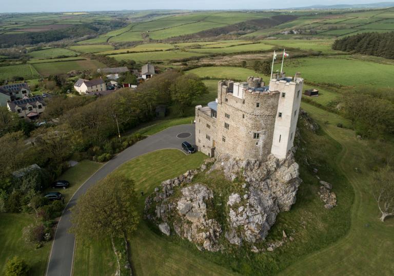 An aerial shot of Roch Castle set amongst the rolling hills and valleys.