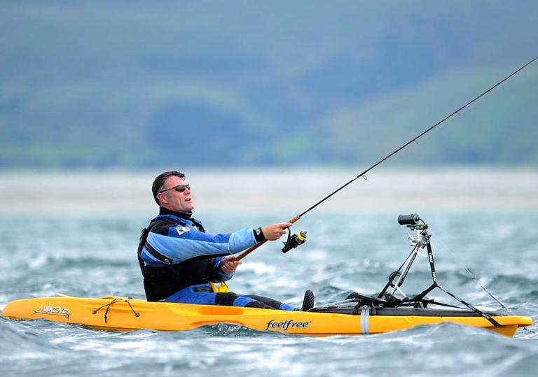 Image of Julian Lewis Jones fishing from a kayak with a fishing rod