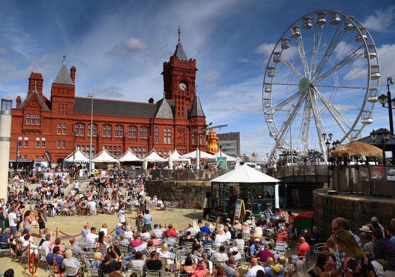 Crowds in sunny bayside area in front of Pierhead building