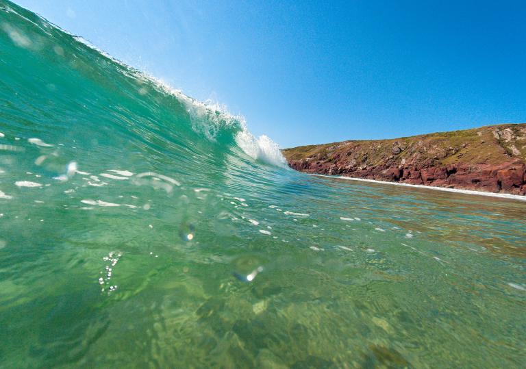 Wave crashing onto a Pembrokeshire beach.