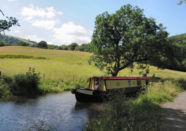 Canal boat on water at Monmouthshire and Brecon Canal.
