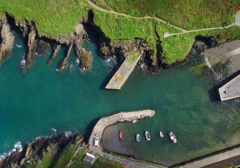 Aerial view of Porthgain Harbour and some small boats.