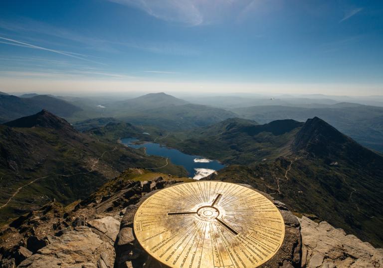 Trig point on top of Yr Wyddfa  (Snowdon) looking over the lakes.