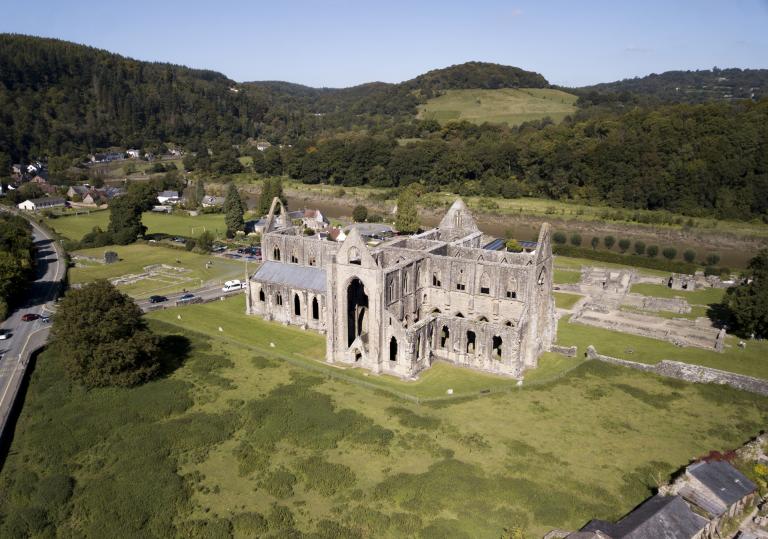 aerial view of remains of abbey with surrounding countryside.