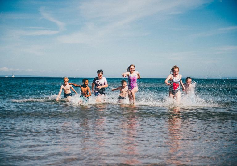 Children running in sea