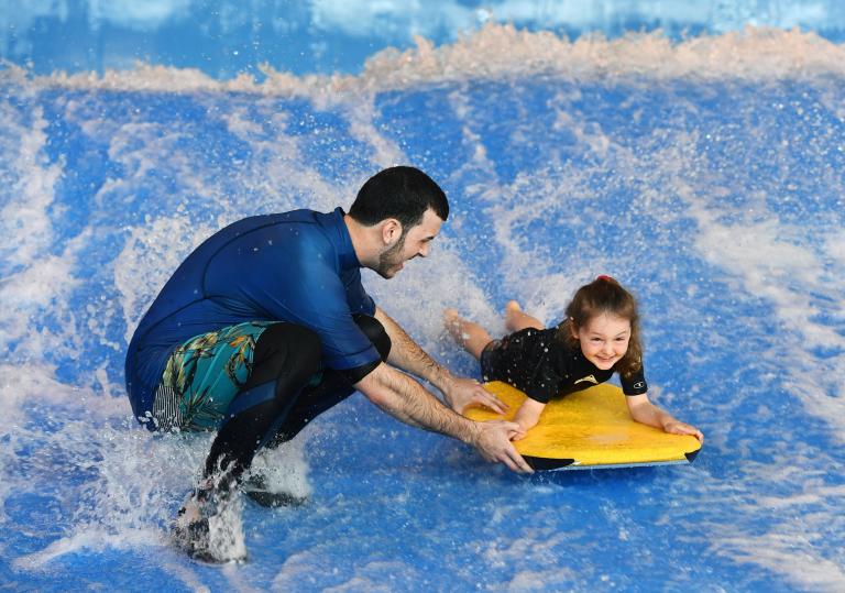 Young child body boarding at Cardiff International White Water
