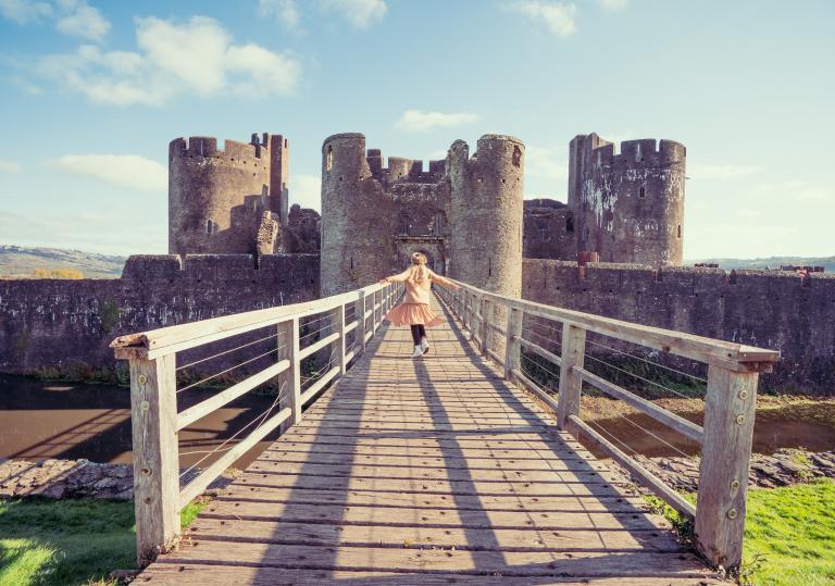 Girl entering Caerphilly Castle on the drawbridge.