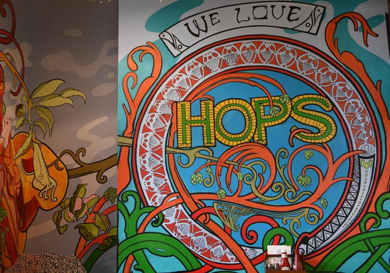 Colourful mural with 'We love hops' text.