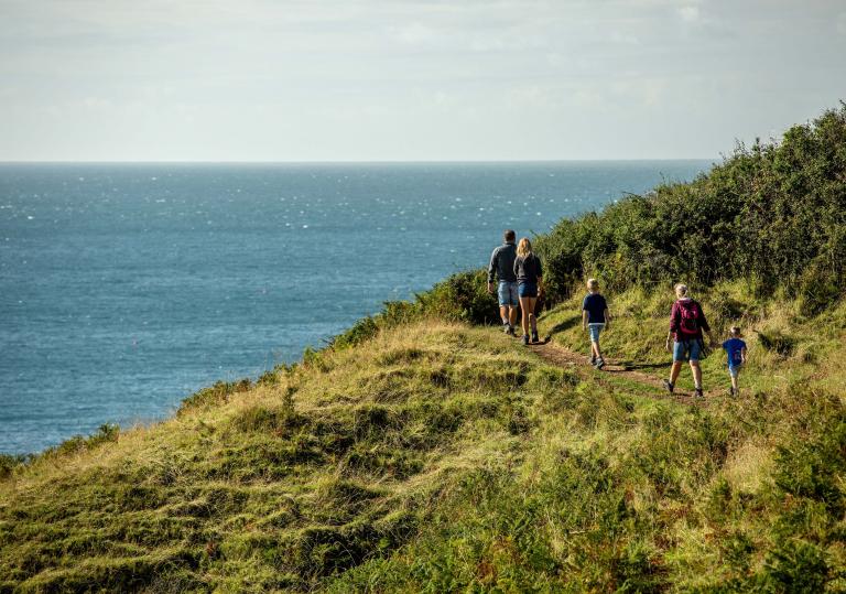 Family walking on coastal path at Aberdaron.