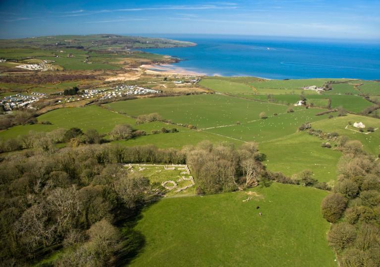 Ariel view of a campsite, surrounding fields and the coastline of Anglesey, North Wales.