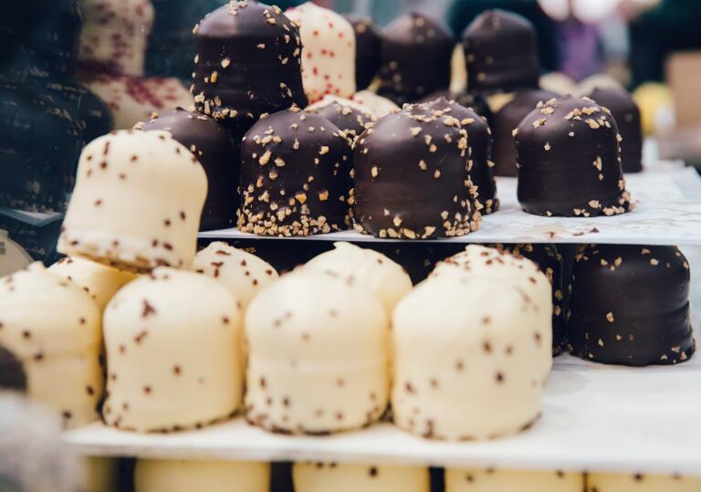 white and milk chocolate truffles stacked on a display stand