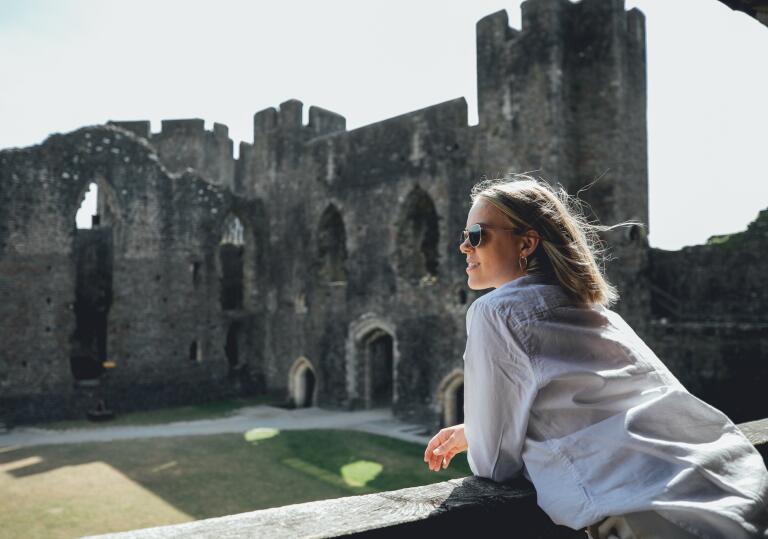woman inside castle ruins.