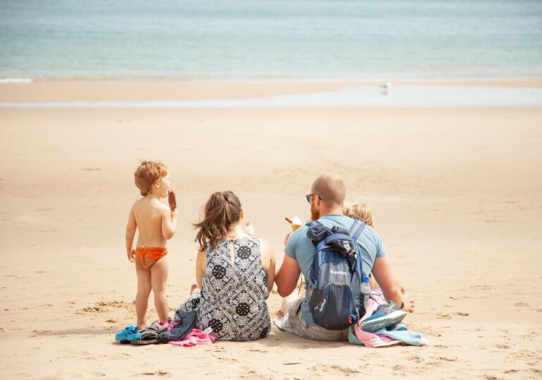 family on sandy beach.