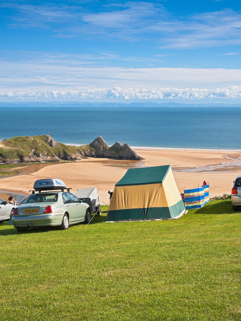 Cars and tents overlooking beach