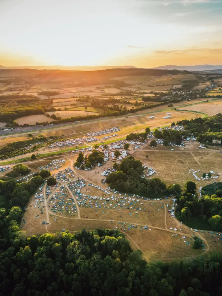 Aerial view of a festival field with many tents.