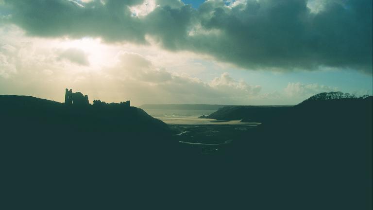 Cloudy image of the ruins of Pennard Castle
