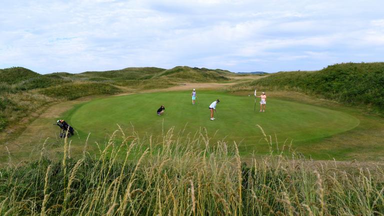 Four lady golfers on the green awaiting for a putt to be sunk at Pyle and Kenfig Golf Club.