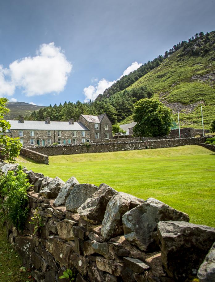 Stone built cottages at Nant Gwrtheyrn looking over the grass square.
