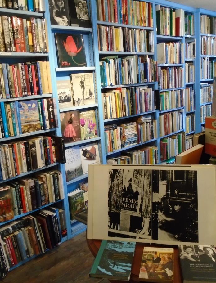 Interior of Antiquariat Broadleaf Books, with tall bookshelves filled with books