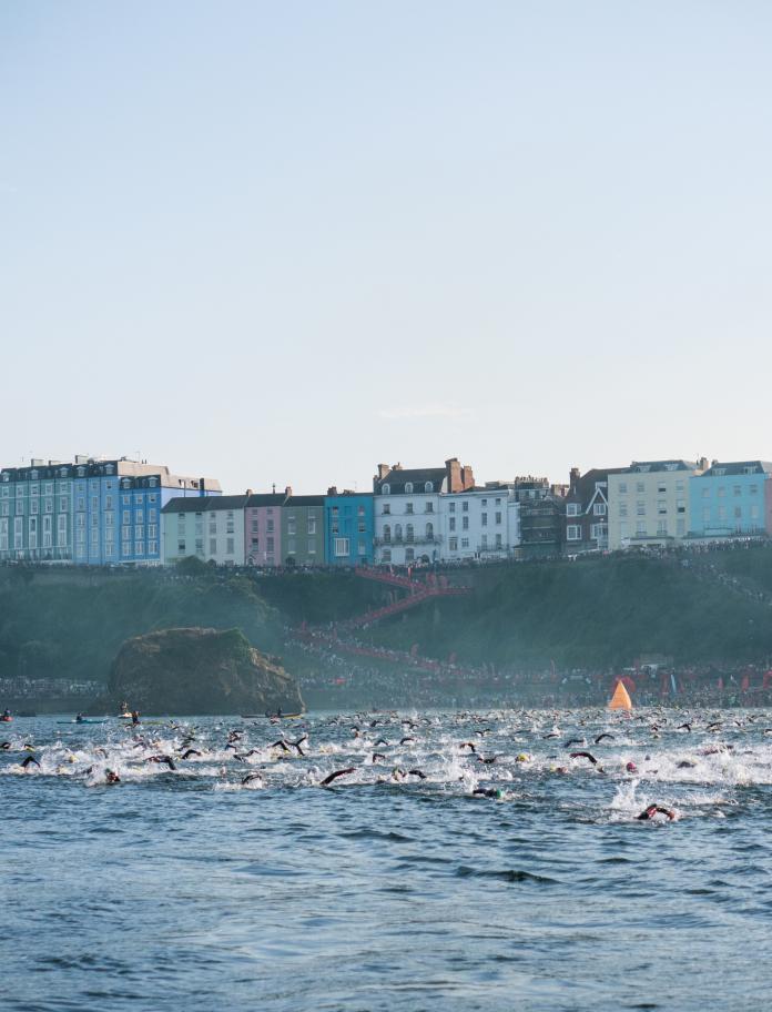 Swimmers racing in the sea around Tenby
