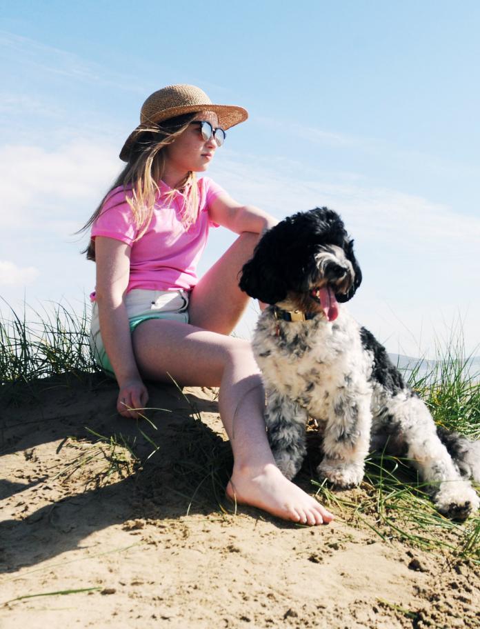 Woman and dog on Cefn Sidan beach.