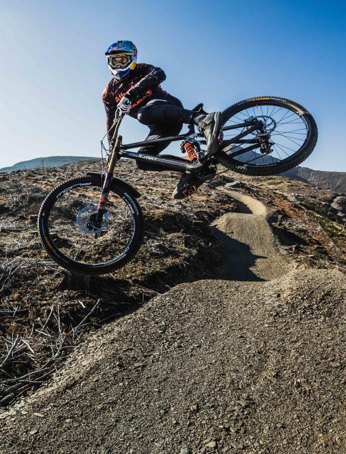 Mountain bike jumping on a trail.