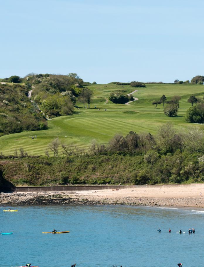Langland Bay with golf course in the background.