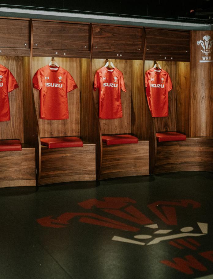 Welsh rugby shirts hung up in a dressing room.