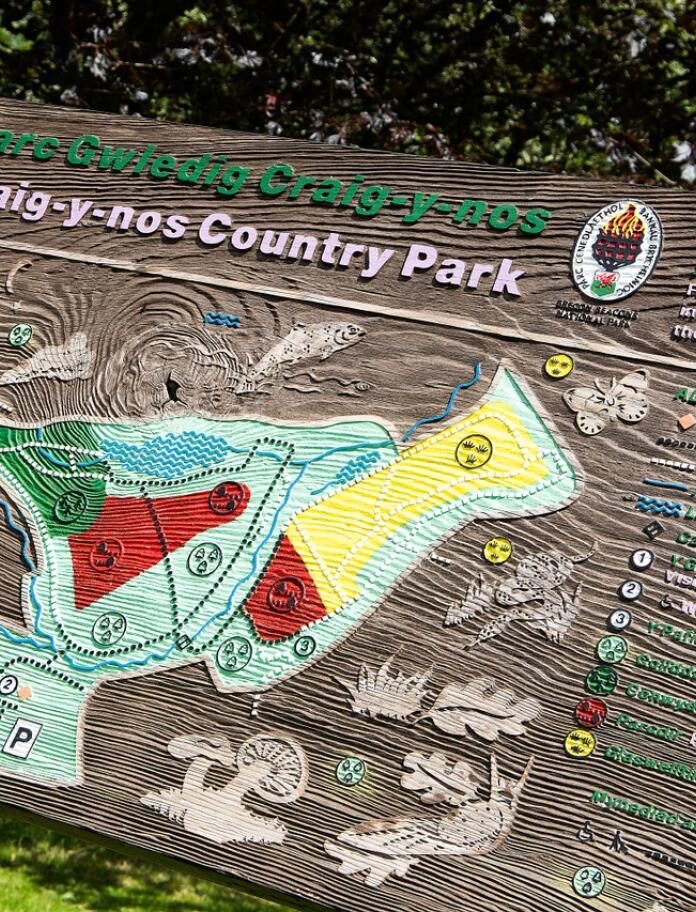 Craig-y-Nos Country Park wooden sign and map.