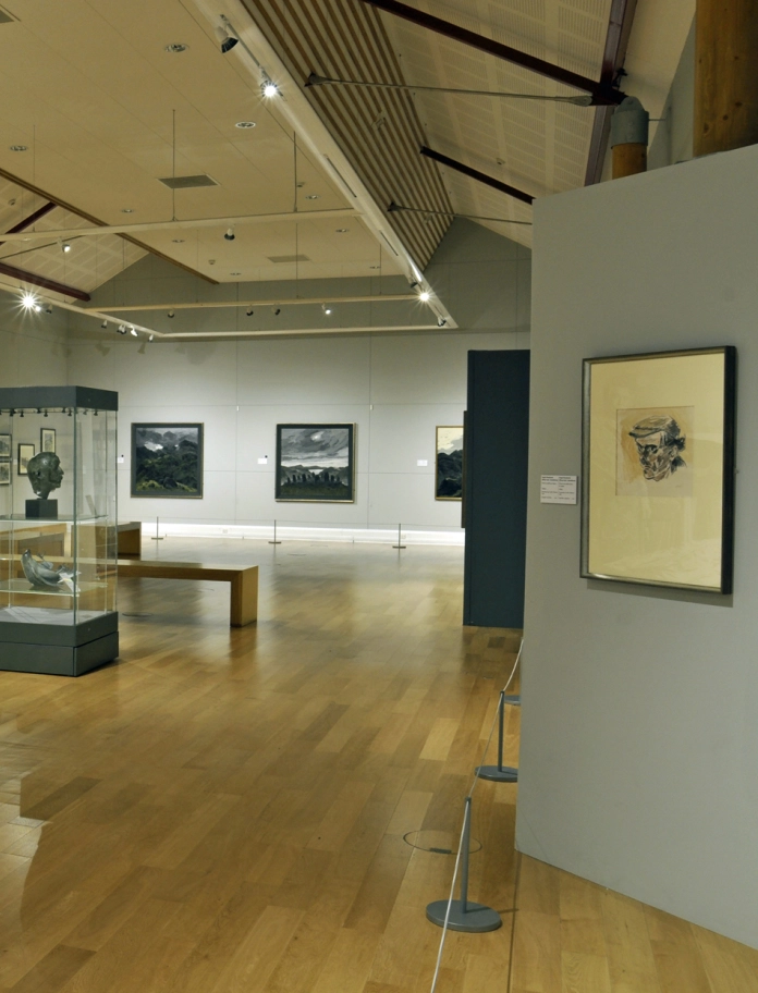 art gallery with works of art and signage Sir Kyffin Williams collection, Oriel Môn museum and gallery.