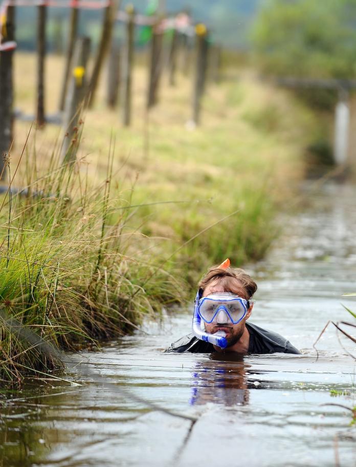 Man snorkelling through a bog