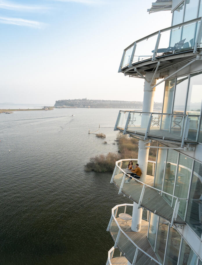 A hotel balcony overlooking a city bay.