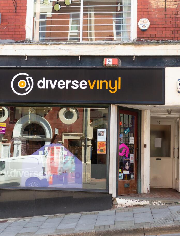 Outside a record shop with 'diverse vinyl' text in white and yellow.