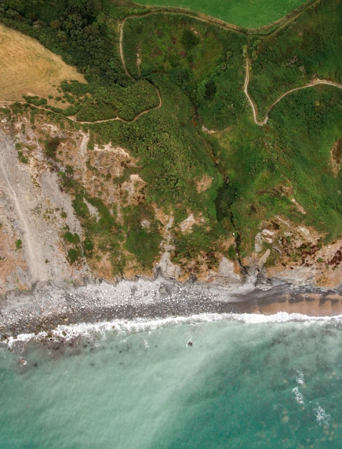 Pathways along the coastline from above.