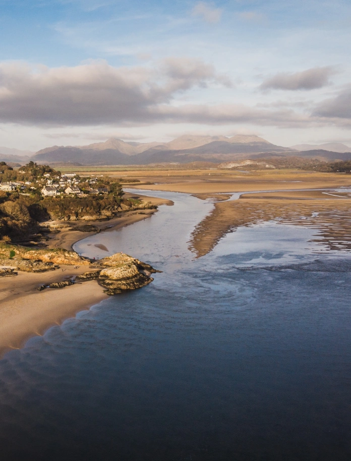A sandy beach on an estuary from above.