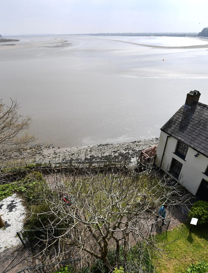White house and garden overlooking the sea.