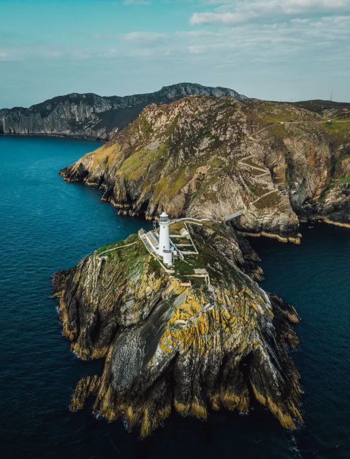 Aerial image of lighthouse on a rock.